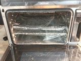 a silver oven that is sitting on top of a counter