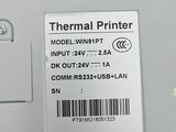 a picture of a thermal printer on a wooden table