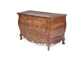 an antique chest of drawers with ornate carvings and brass handles