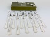 a lot of forks and spoons that are on a table