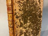 a close up of a book on a table with a piece of paper sticking out of it
