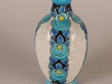 a blue and white vase sitting on a table