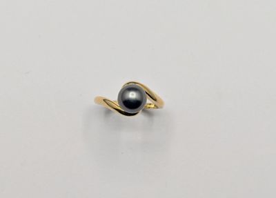 an image of a black pearl ring on a white surface