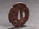 a small piece of metal that looks like a tsuba