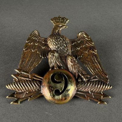 a bronze eagle on top of a ball with two wings