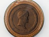 an image of a bronze medal with a woman ' s profile