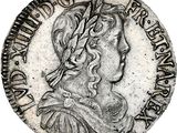 a silver coin with an image of a woman in profile