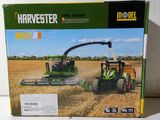 a box with a picture of a tractor and a combiner in it