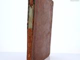 an old book that is sitting on a table
