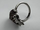 a close up of a silver ring with garnets on it