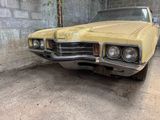 a yellow car that is parked in a garage
