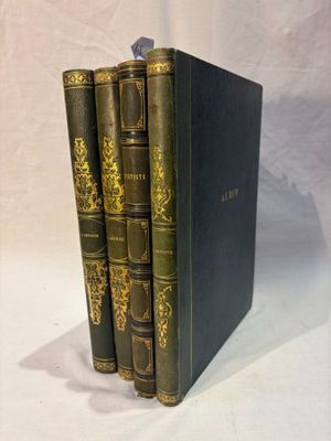 three books are stacked on top of each other on a white surface