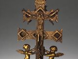 an image of a cross with angels on it and a bird on top of it
