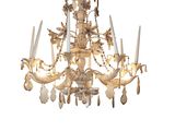 a chandelier made of wood and glass hanging from the ceiling