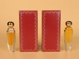 deux flacons de parfum posés l'un à côté de l'autre sur une table