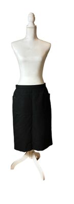 a mannequin with a black skirt on a white mannequin stand