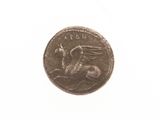 an old coin with a dragon on it on a white surface