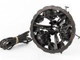 an image of a metal object with a bunch of black flowers on it