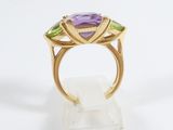 an image of a gold ring with amethorate, peridot and amethorate