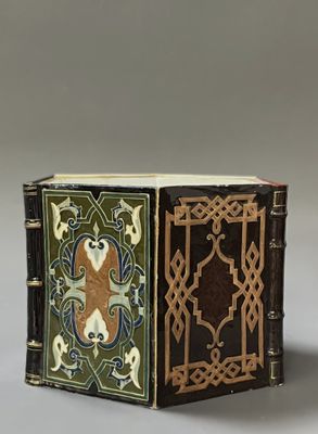 an old book with a decorative design on the cover