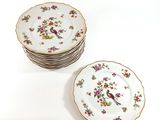 a stack of plates with birds and flowers on them