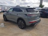 the rear end of a grey suv parked in a lot