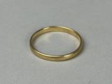 a close up of a gold ring on a white surface