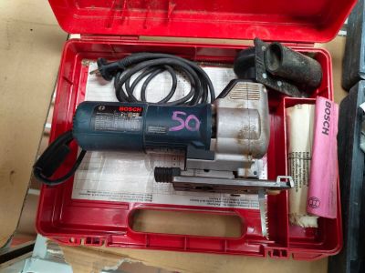 a red tool box with a drill and other tools in it
