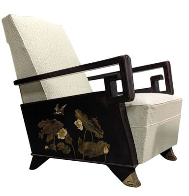 an upholstered chair with a floral design on the back