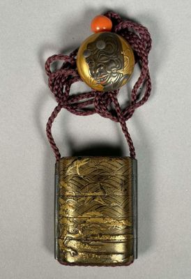 a close up of a small metal object with a red bead on it