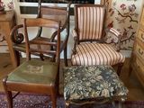 two chairs and a stool in the corner of a room