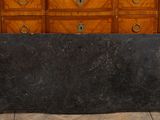 a large black bag sitting on the floor in front of a dresser