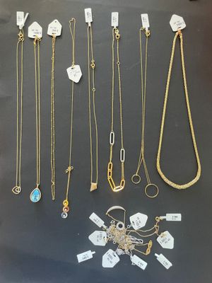 a group of necklaces and bracelets are displayed on a table