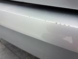 a close up of a car ' s bumper with scratches on it
