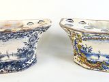 pair of blue and white vases on a white background
