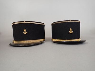 pair of black and gold hats with gold trims on them