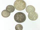 several coins are arranged in a circle on a white surface