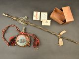 a small box with a necklace and a stick with a picture on it