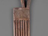 an image of a wooden comb on a gray surface