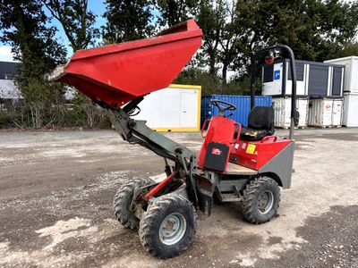 a red tractor with a red dumper attached to it