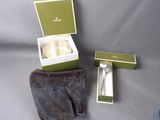 a box with a silver spoon and a silver spoon in it