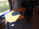 a desk with a chair in front of a window