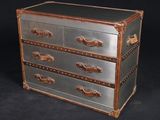 a metal chest with three drawers on top of it