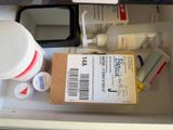 a box of medicine sitting on a counter next to a bottle of medicine
