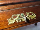 a close up of a wooden table with a drawer on it