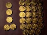 a lot of gold coins sitting on a table