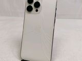 a close up of a white iphone with a broken screen