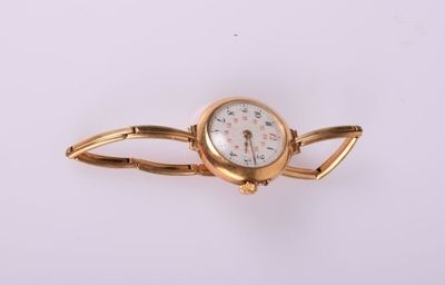 une image d'un gros plan d'une montre-bracelet sur une surface blanche