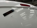 a sticker on the back of a white car in a garage