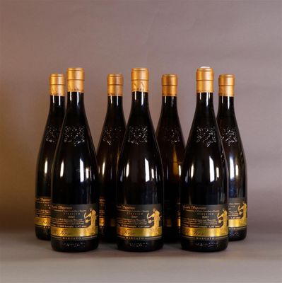 four bottles of wine are lined up on a table